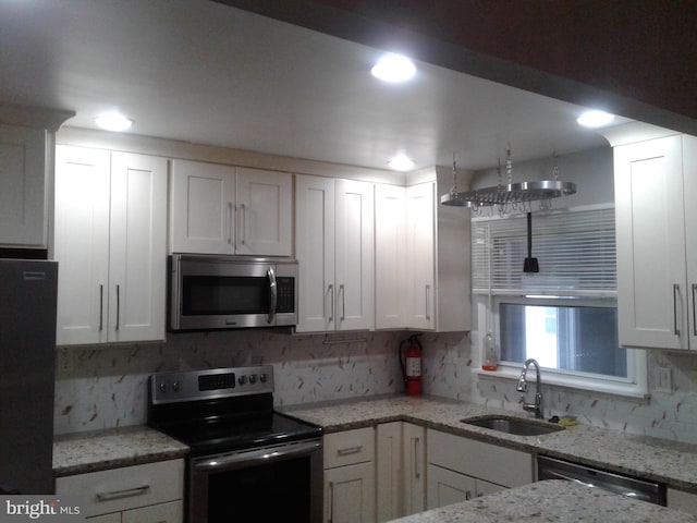 1209 Idylwood Rd, Pikesville, MD 21208 - kitchen featuring appliances with stainless steel finishes, decorative backsplash, white cabinets, light stone countertops, and recessed lighting