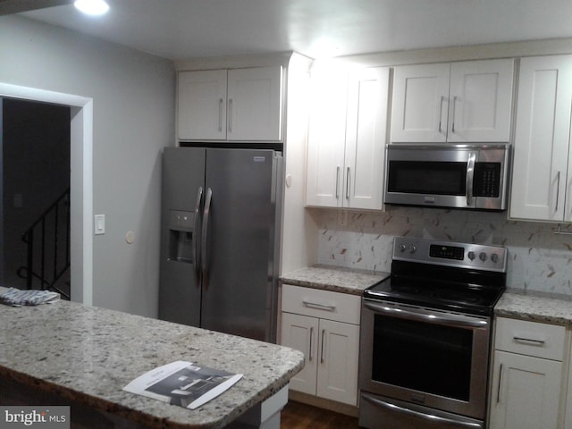 1209 Idylwood Rd, Pikesville, MD 21208 - kitchen featuring stainless steel appliances, tasteful backsplash, and white cabinetry