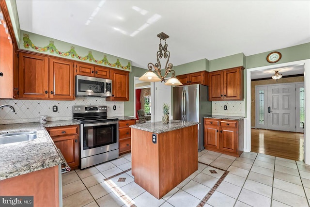 14 Pond View Ln, Malvern, PA 19355 - kitchen with stainless steel appliances, light tile patterned flooring, a center island, and backsplash