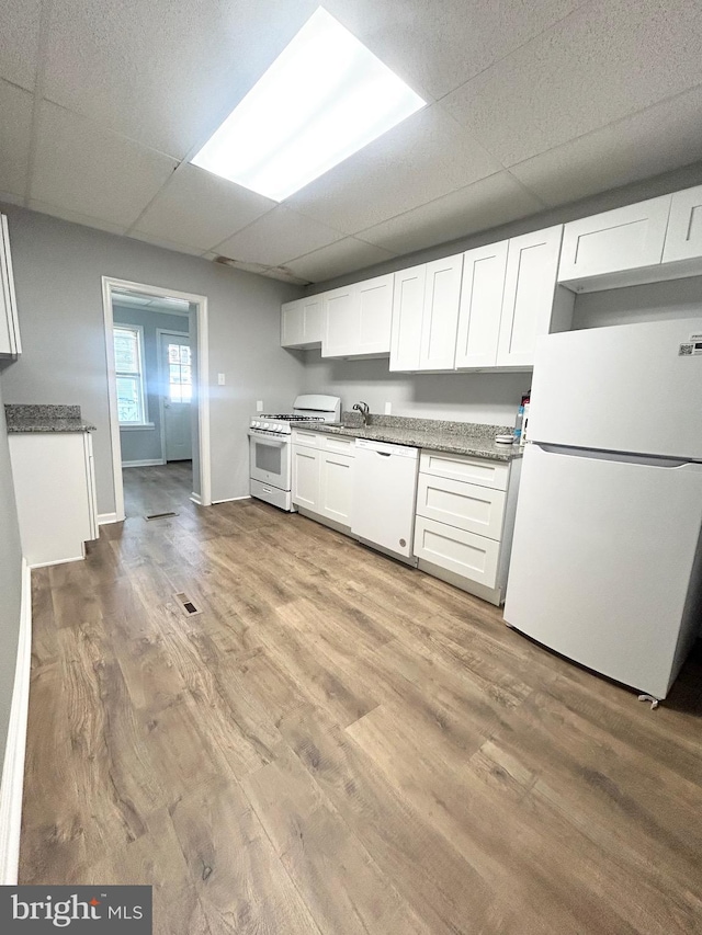 533 Franklin St, West Reading, PA 19611 - kitchen featuring white appliances, a paneled ceiling, light wood-type flooring, and white cabinetry