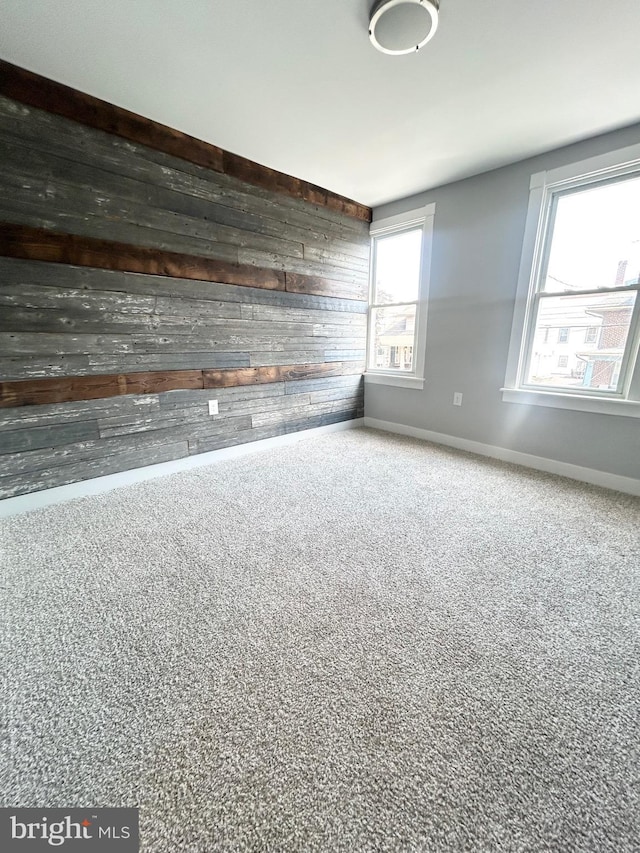 533 Franklin St, West Reading, PA 19611 - empty room with wood walls and carpet floors