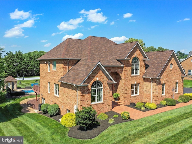 22124 Whitestone Ct, Smithsburg, MD 21783 - view of front facade with brick siding, a front lawn, and roof with shingles