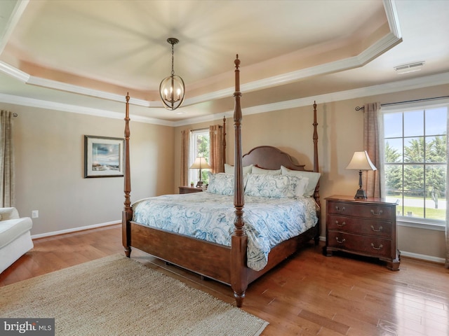 22124 Whitestone Ct, Smithsburg, MD 21783 - bedroom featuring a tray ceiling, wood finished floors, a chandelier, and crown molding