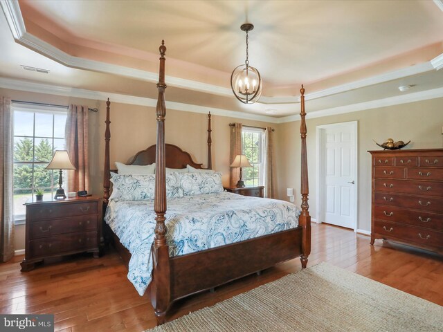 22124 Whitestone Ct, Smithsburg, MD 21783 - bedroom featuring a tray ceiling, wood finished floors, a chandelier, and crown molding