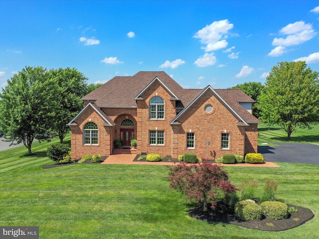 22124 Whitestone Ct, Smithsburg, MD 21783 - view of front of house featuring brick siding, roof with shingles, and a front yard
