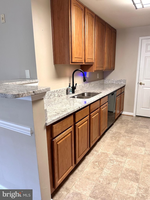8980 Harrover Pl Unit 80B, Lorton, VA 22079 - kitchen with dishwashing machine, brown cabinets, and light stone counters