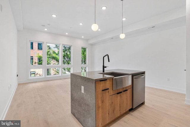 1338 N Franklin St, Philadelphia, PA 19122 - kitchen with stainless steel dishwasher, modern cabinets, dark stone counters, light wood finished floors, and a center island with sink