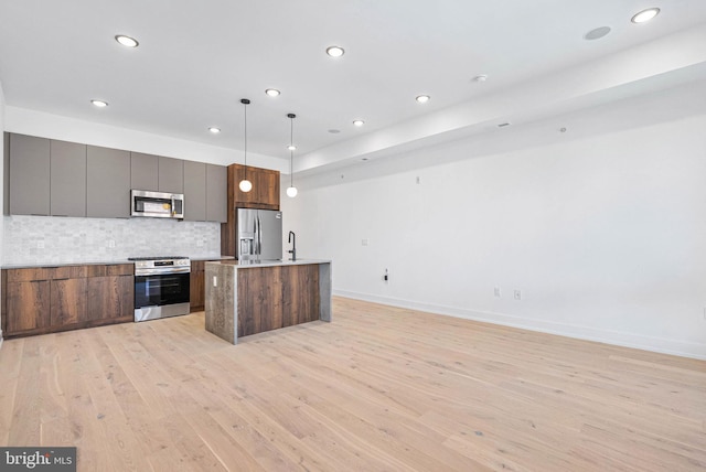 1338 N Franklin St, Philadelphia, PA 19122 - kitchen with appliances with stainless steel finishes, light wood-type flooring, backsplash, recessed lighting, and open floor plan