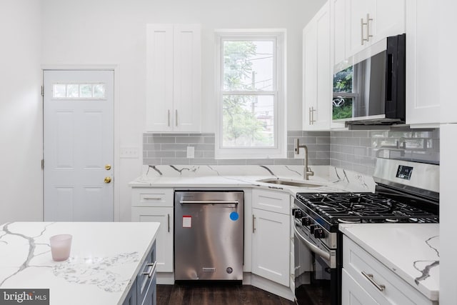 721 E 22nd St, Baltimore, MD 21218 - kitchen with stainless steel appliances, tasteful backsplash, white cabinetry, dark wood-type flooring, and light stone countertops