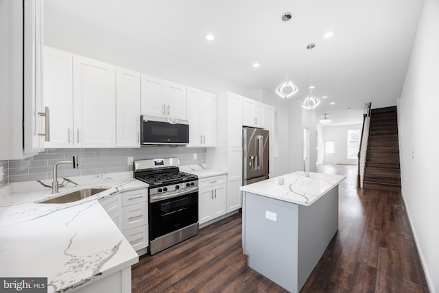721 E 22nd St, Baltimore, MD 21218 - kitchen with appliances with stainless steel finishes, tasteful backsplash, white cabinets, recessed lighting, and a kitchen island