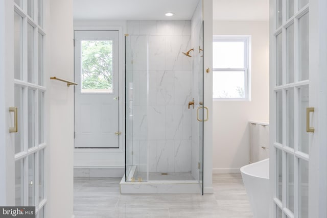 721 E 22nd St, Baltimore, MD 21218 - full bath featuring a marble finish shower, a soaking tub, french doors, and recessed lighting