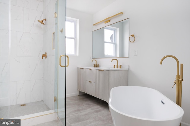721 E 22nd St, Baltimore, MD 21218 - bathroom featuring a shower stall, a freestanding bath, and double vanity