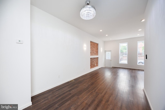 721 E 22nd St, Baltimore, MD 21218 - unfurnished room with dark wood finished floors, recessed lighting, and a chandelier