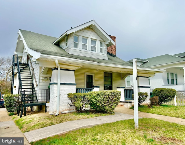 5904 Harford Rd, Baltimore, MD 21214 - view of front facade with covered porch, stairway, a chimney, and a shingled roof
