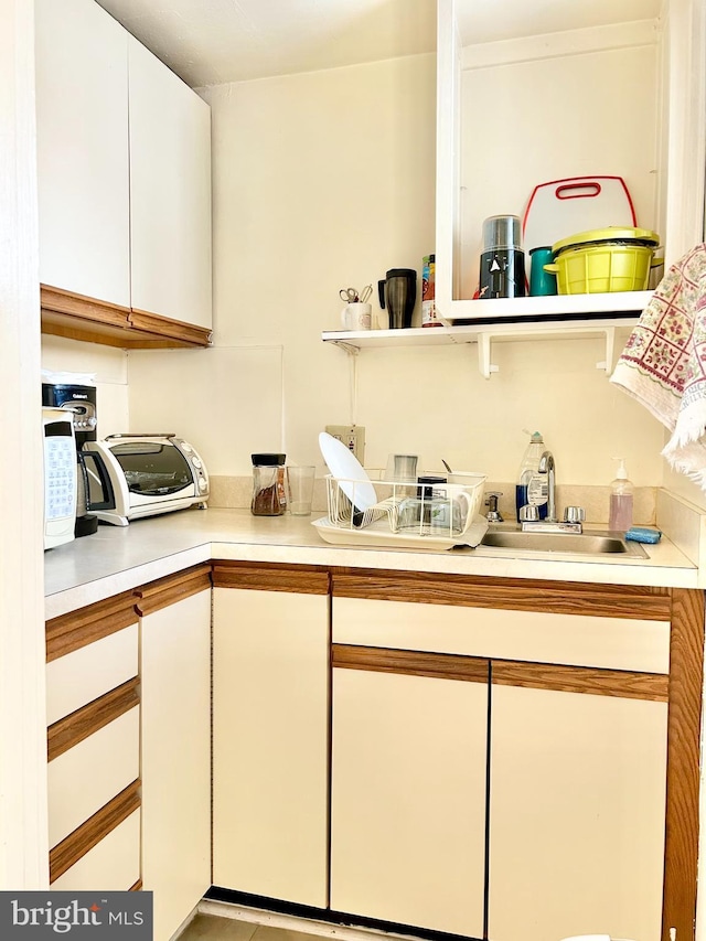 5904 Harford Rd, Baltimore, MD 21214 - kitchen with light countertops and white cabinetry