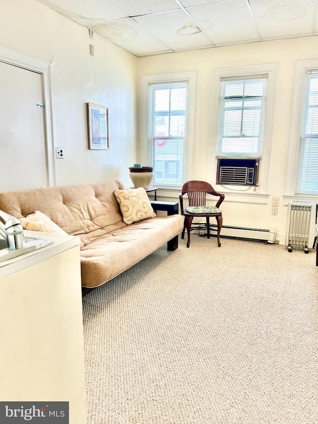 5904 Harford Rd, Baltimore, MD 21214 - living area featuring cooling unit, radiator, a baseboard radiator, a drop ceiling, and carpet floors