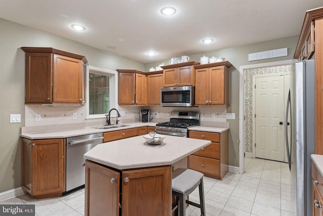 16 Fox Hollow Dr, Lancaster, PA 17602 - kitchen with appliances with stainless steel finishes, light countertops, light tile patterned flooring, brown cabinets, and a kitchen bar