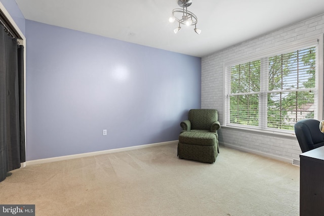 16 Fox Hollow Dr, Lancaster, PA 17602 - sitting room featuring brick wall, carpet floors, and plenty of natural light