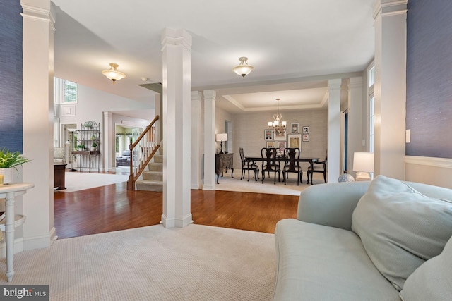 16 Fox Hollow Dr, Lancaster, PA 17602 - carpeted living room featuring decorative columns, stairs, a chandelier, and wood finished floors