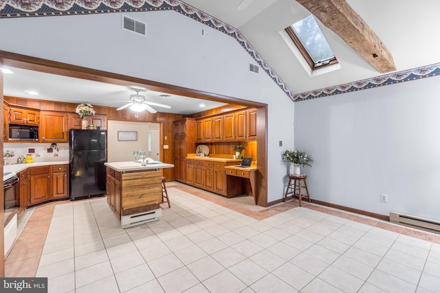 643 Meadow Branch Rd, Westminster, MD 21158 - kitchen with black appliances, light tile patterned flooring, a skylight, light countertops, and beamed ceiling