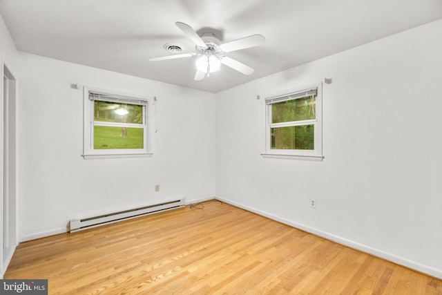 643 Meadow Branch Rd, Westminster, MD 21158 - empty room featuring a baseboard radiator, plenty of natural light, wood finished floors, and a ceiling fan