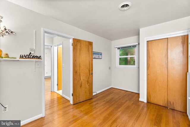 643 Meadow Branch Rd, Westminster, MD 21158 - unfurnished bedroom featuring light wood-style flooring and a closet