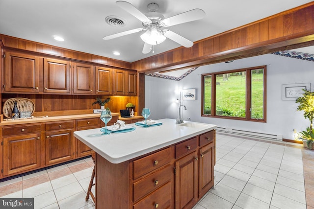643 Meadow Branch Rd, Westminster, MD 21158 - kitchen featuring a baseboard radiator, light countertops, light tile patterned floors, and brown cabinetry