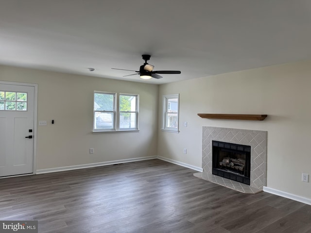 313 W Third St, Camden Wyoming, DE 19934 - unfurnished living room with plenty of natural light, a fireplace, ceiling fan, and dark wood-style flooring