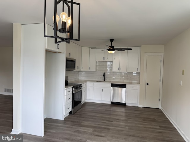 313 W Third St, Camden Wyoming, DE 19934 - kitchen with appliances with stainless steel finishes, light countertops, white cabinetry, ceiling fan, and backsplash