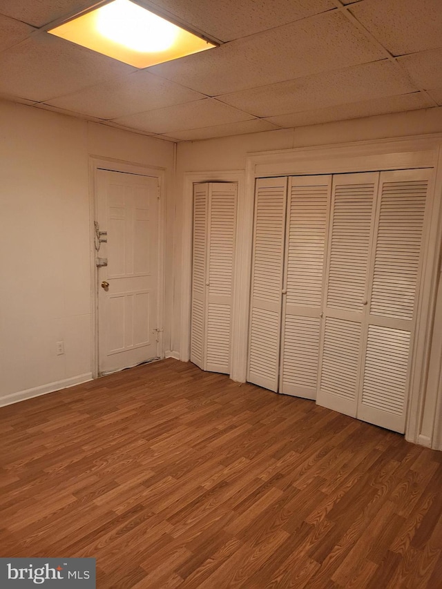 33 S Iowa Unit B1, Atlantic City, NJ 08401 - unfurnished bedroom featuring light wood-type flooring, two closets, and a paneled ceiling