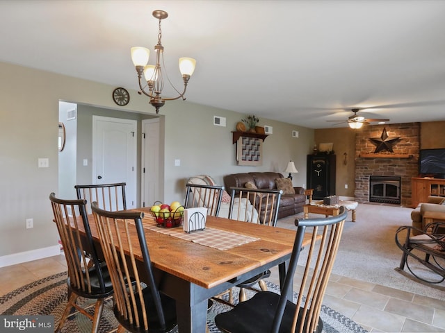647 Warm Spring Rd, Chambersburg, PA 17202 - dining area featuring ceiling fan, a fireplace, a chandelier, and light tile patterned floors