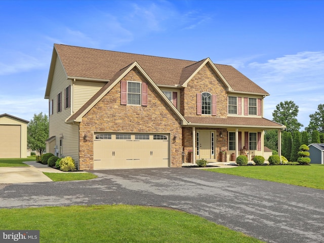 647 Warm Spring Rd, Chambersburg, PA 17202 - view of front of property with a porch, stone siding, an attached garage, driveway, and a front lawn