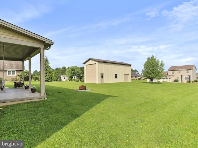 647 Warm Spring Rd, Chambersburg, PA 17202 - view of green lawn featuring a detached garage, a patio, an outdoor structure, and an outdoor fire pit