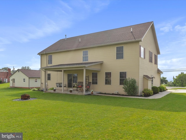 647 Warm Spring Rd, Chambersburg, PA 17202 - back of property featuring an outdoor fire pit, a patio area, and a lawn