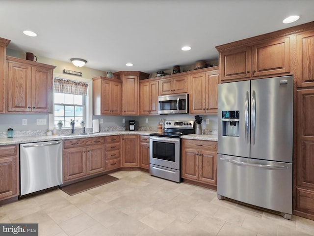 647 Warm Spring Rd, Chambersburg, PA 17202 - kitchen with stainless steel appliances, brown cabinetry, recessed lighting, and light stone counters