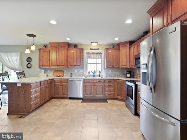 647 Warm Spring Rd, Chambersburg, PA 17202 - kitchen with appliances with stainless steel finishes, a peninsula, a breakfast bar, brown cabinetry, and recessed lighting