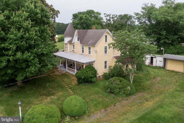 35118 Roxana Rd, Frankford, DE 19945 - view of side of property with a chimney, a shingled roof, a porch, and view of scattered trees