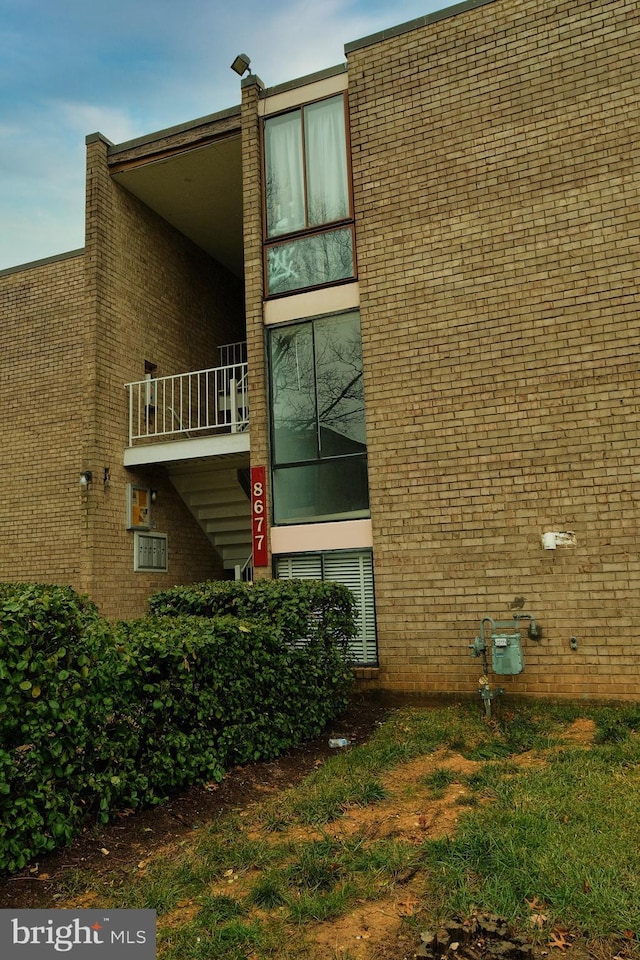 8677 Greenbelt Rd Unit 101, Greenbelt, MD 20770 - view of side of property with brick siding and a balcony