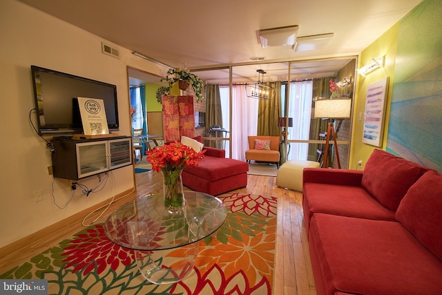 8677 Greenbelt Rd Unit 101, Greenbelt, MD 20770 - living area featuring wood-type flooring and a chandelier