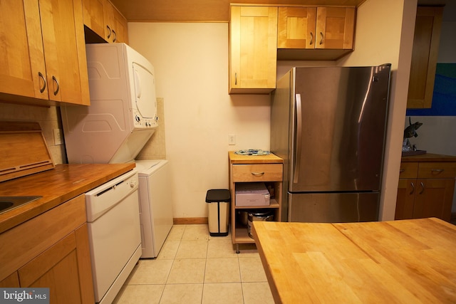 8677 Greenbelt Rd Unit 101, Greenbelt, MD 20770 - kitchen featuring wood counters, freestanding refrigerator, stacked washer and clothes dryer, and white dishwasher