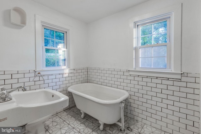 1801 Stringtown Rd, Sparks Glencoe, MD 21152 - bathroom featuring tile walls, tile patterned floors, a freestanding tub, and wainscoting