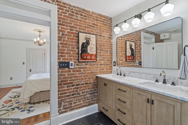 4300 Evans Chapel Rd, Baltimore, MD 21211 - bathroom featuring double vanity, brick wall, and a chandelier