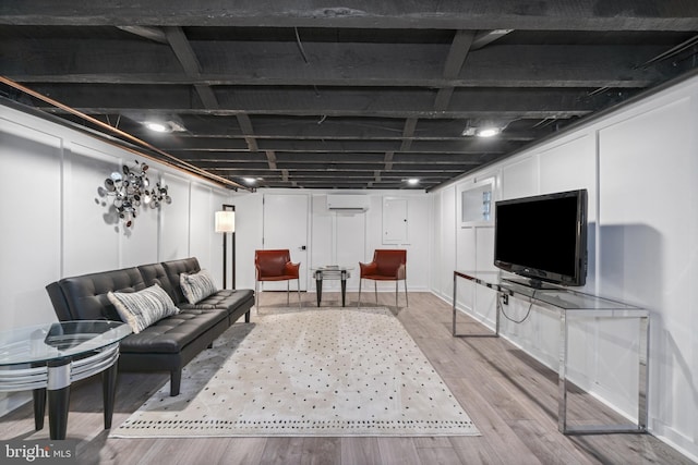4300 Evans Chapel Rd, Baltimore, MD 21211 - living area featuring light wood-type flooring and an AC wall unit