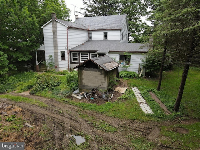 1330 Susquehannock Dr, Drumore, PA 17518 - back of property with a storage shed, a chimney, and roof with shingles