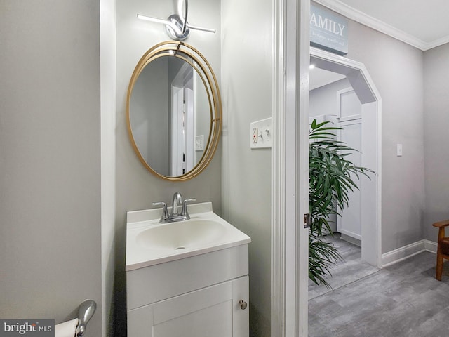1180 Cleveland St, Baltimore, MD 21230 - bathroom featuring wood finished floors, vanity, and ornamental molding