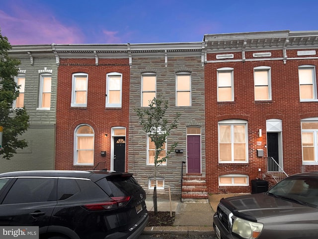 1180 Cleveland St, Baltimore, MD 21230 - view of property featuring entry steps, brick siding, and stone siding