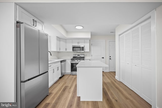 400 Reservoir St, Trenton, NJ 08618 - kitchen with stainless steel appliances, light countertops, a kitchen island, white cabinetry, and light wood finished floors