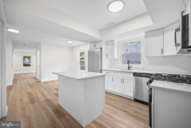 400 Reservoir St, Trenton, NJ 08618 - kitchen with stainless steel appliances, white cabinetry, a kitchen island, light wood-style floors, and recessed lighting