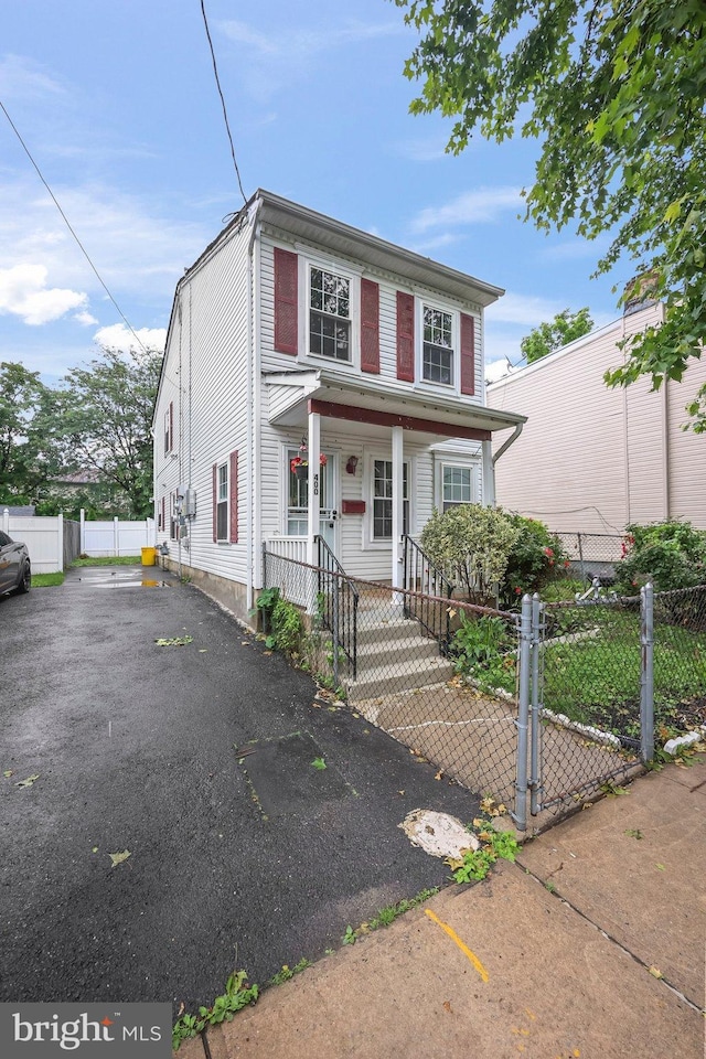400 Reservoir St, Trenton, NJ 08618 - view of front of home featuring a porch, asphalt driveway, and a fenced front yard