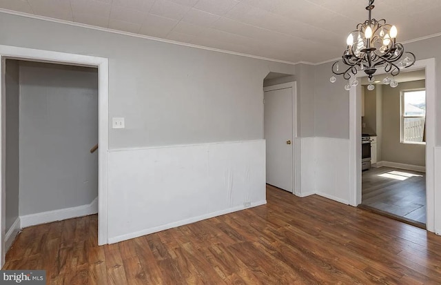 332 E Conestoga Rd, Wayne, PA 19087 - empty room with wood finished floors, crown molding, a chandelier, and wainscoting